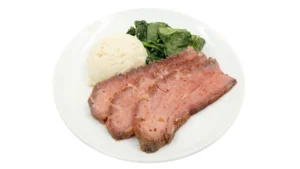 Low calorie meal with lean meat, spinach and smashed potato
